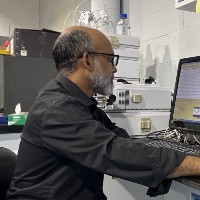 Dr. Nazmul Alam at an HPLC workstation, reviewing a chromatogram