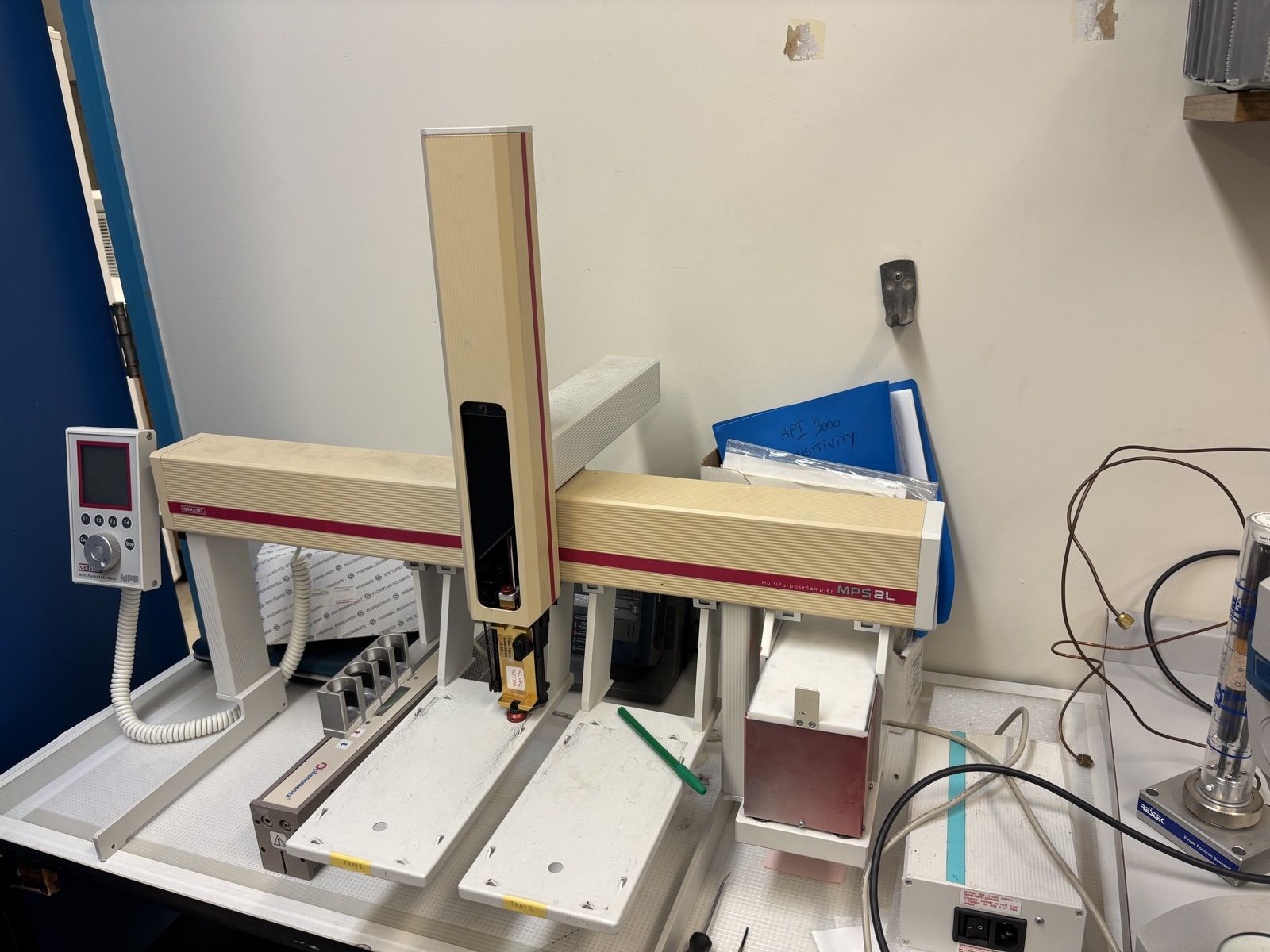 Gerstel MPS 2L multipurpose sampler on a bench, with handheld controller and two sample trays.
